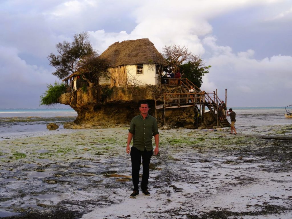 man at low tide at the rock restaurant zanzibar