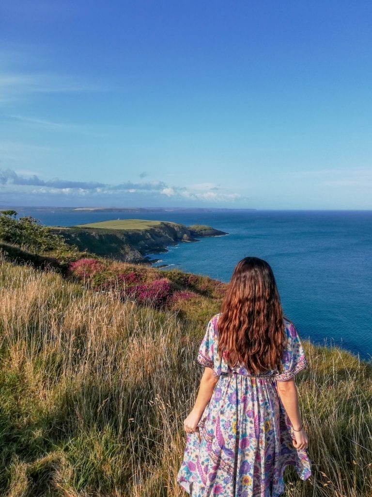 lady at old head kinsale on sunny day