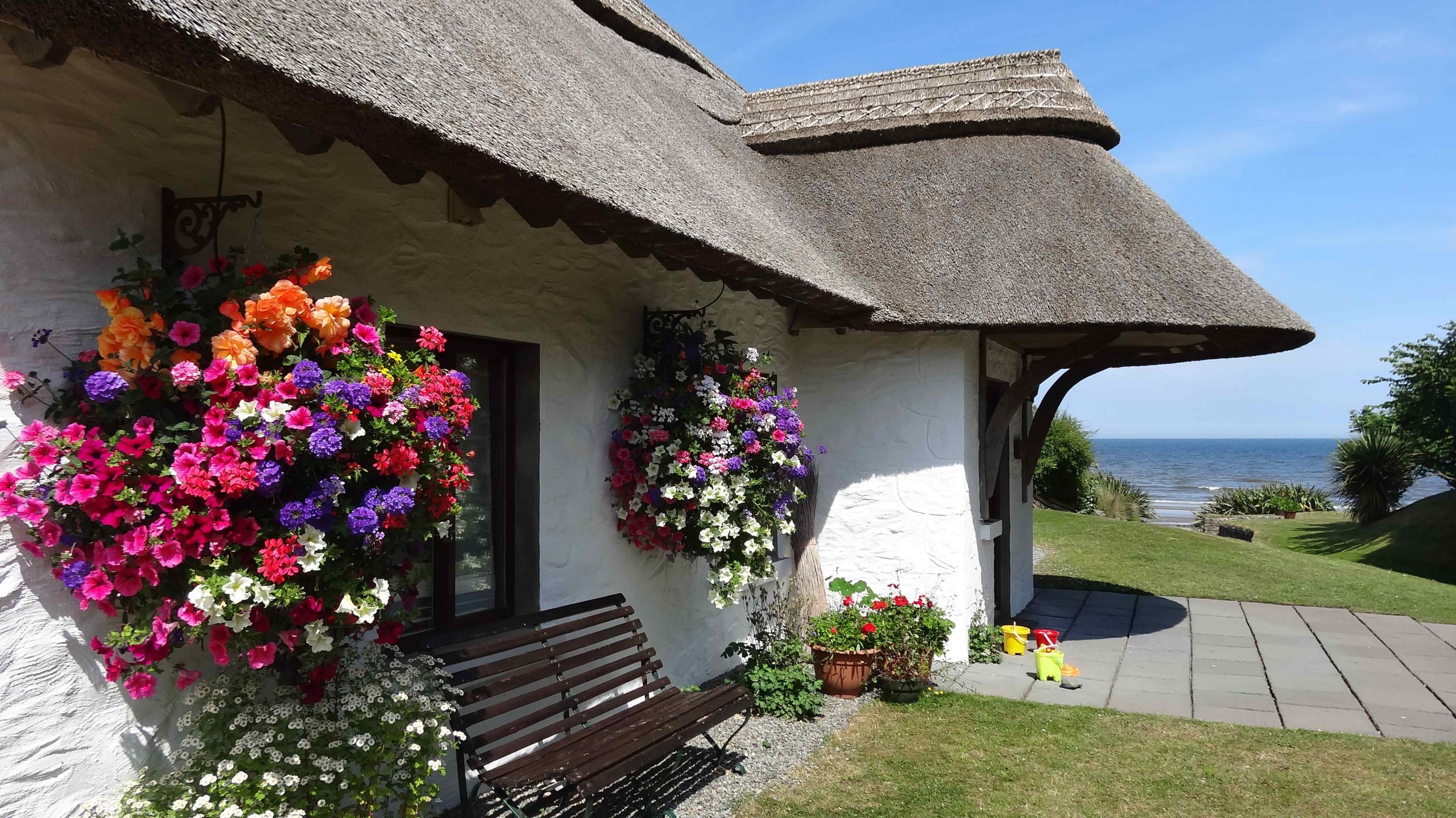 Thatcher’s Rest Cottage with the flower baskets in full bloom