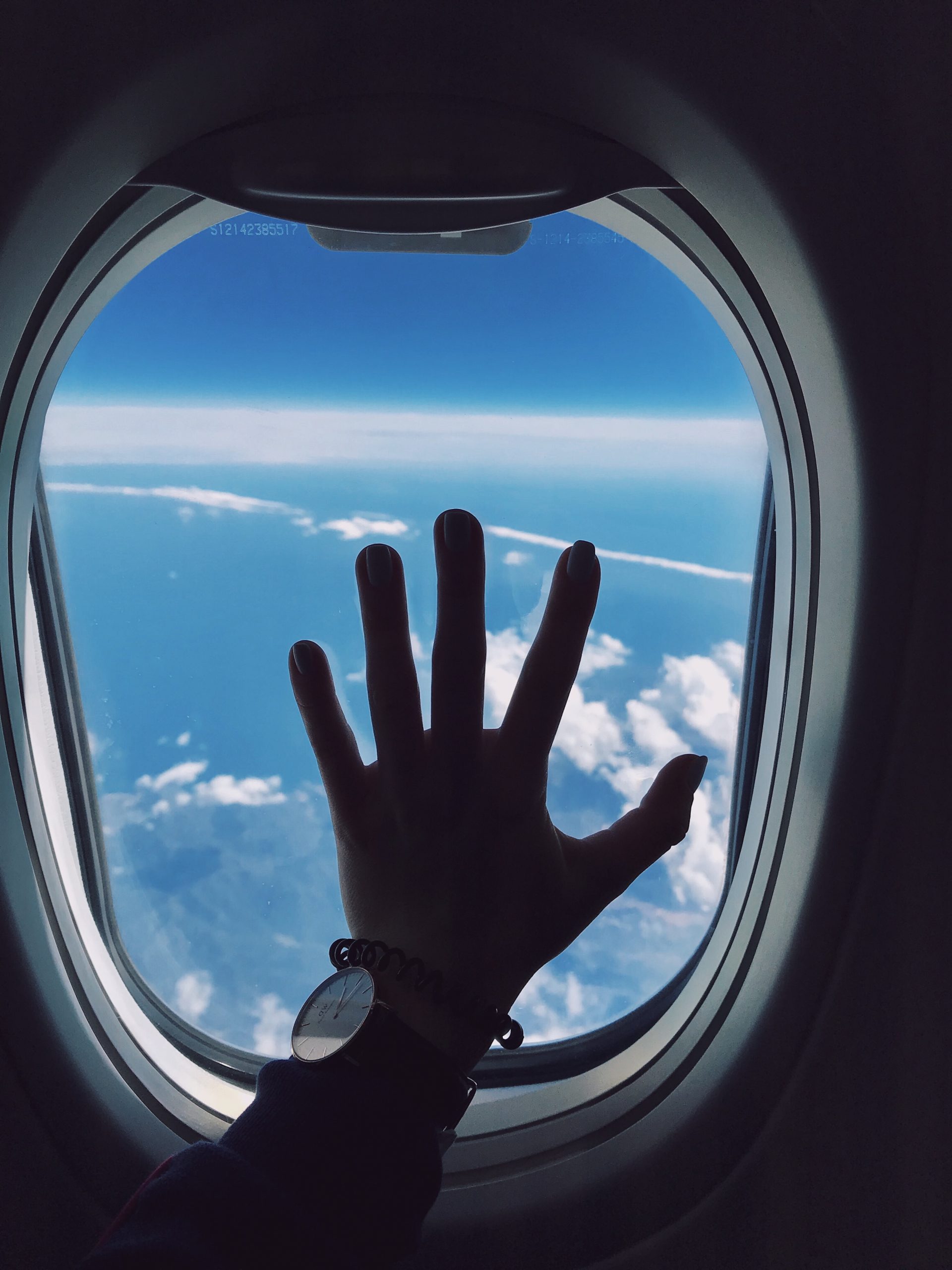 hand on plane window