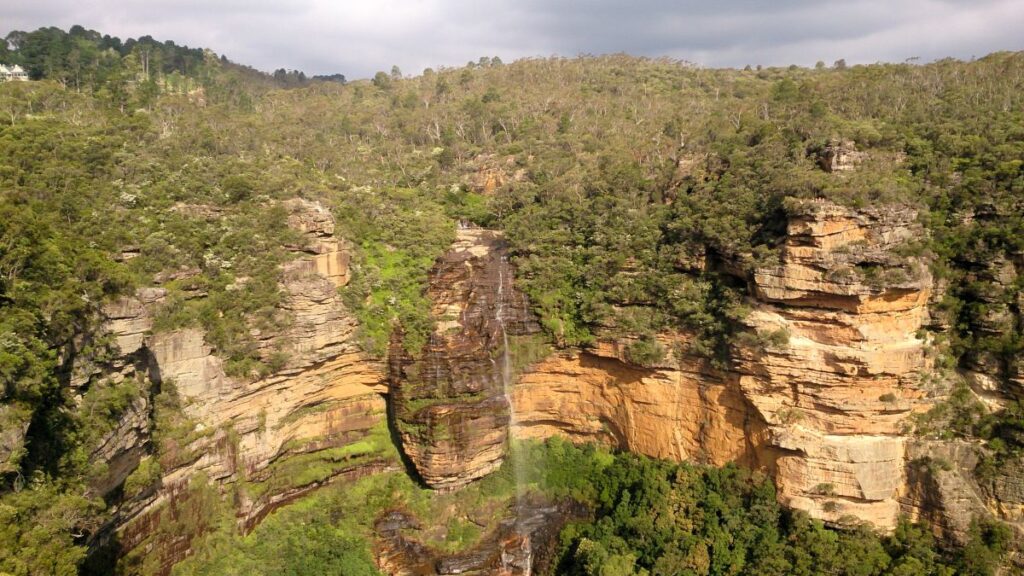 waterfall on blue mountains