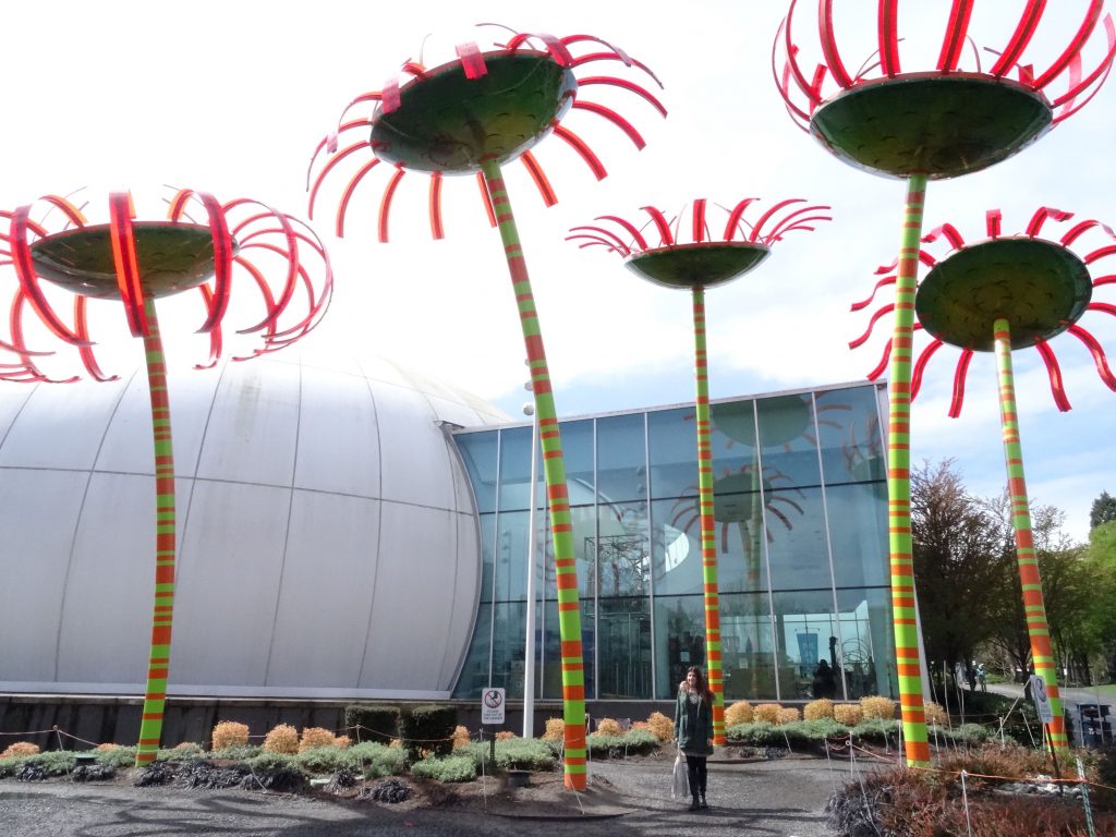 lady standing outside chihuly gardens and glass seattle