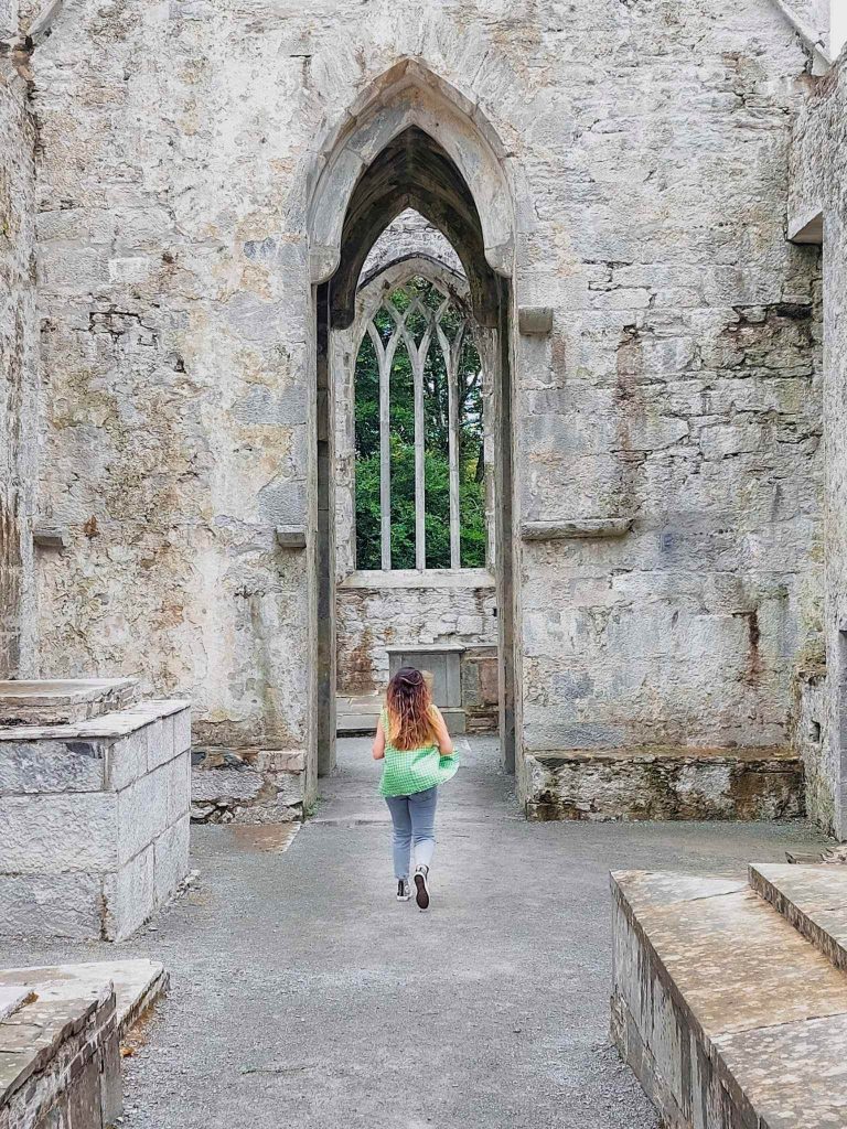 lady runs through muckross abbey