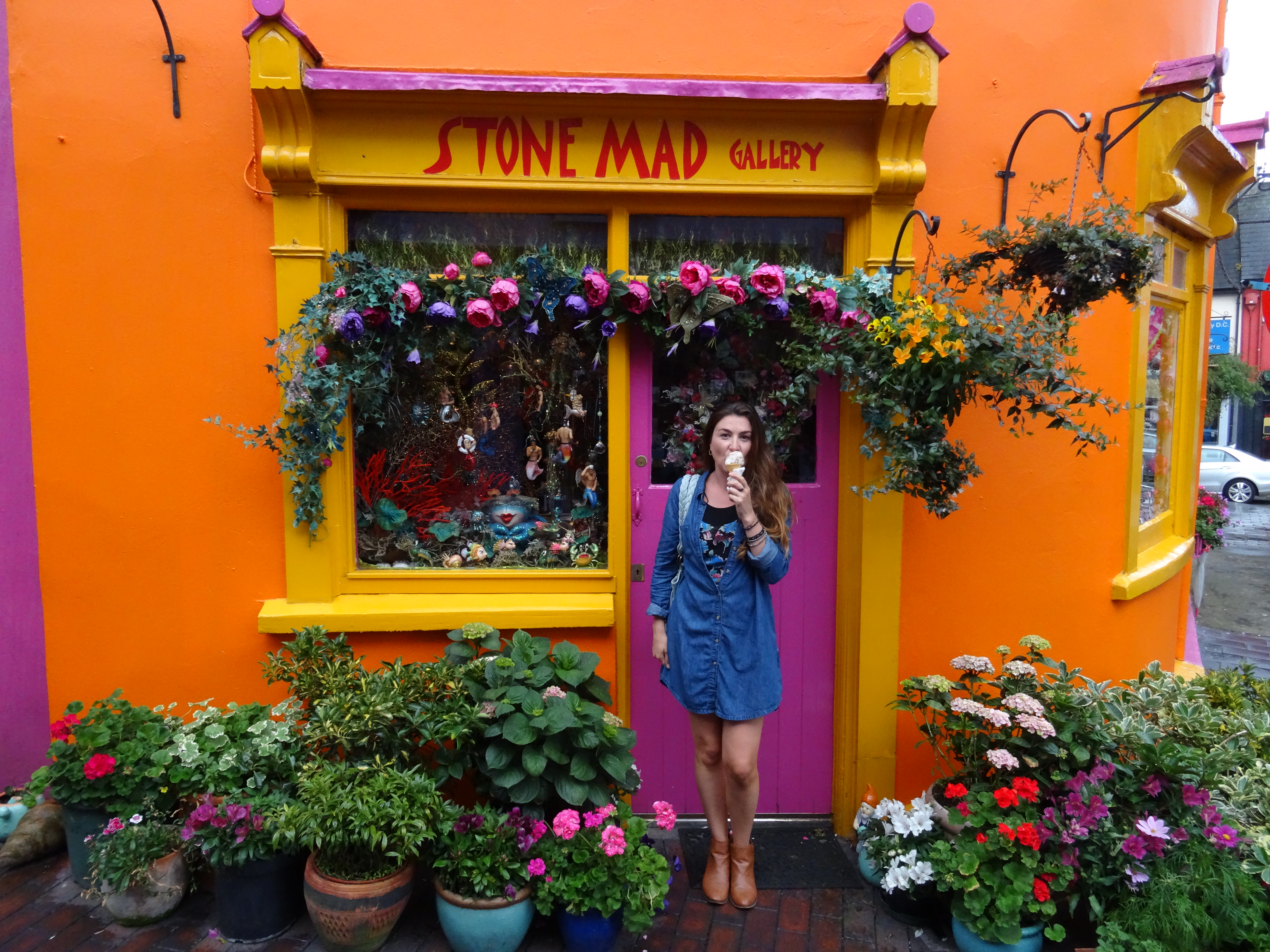 lady in front of colorful store in kinsale