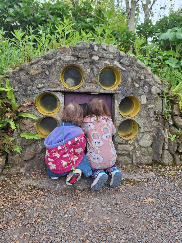 young girls looking at hobbit house glenview gardens