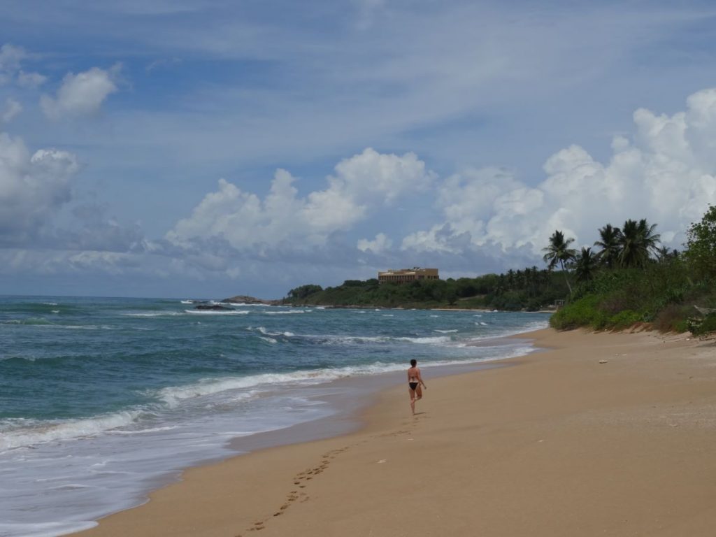 lady walking along rekawa beach