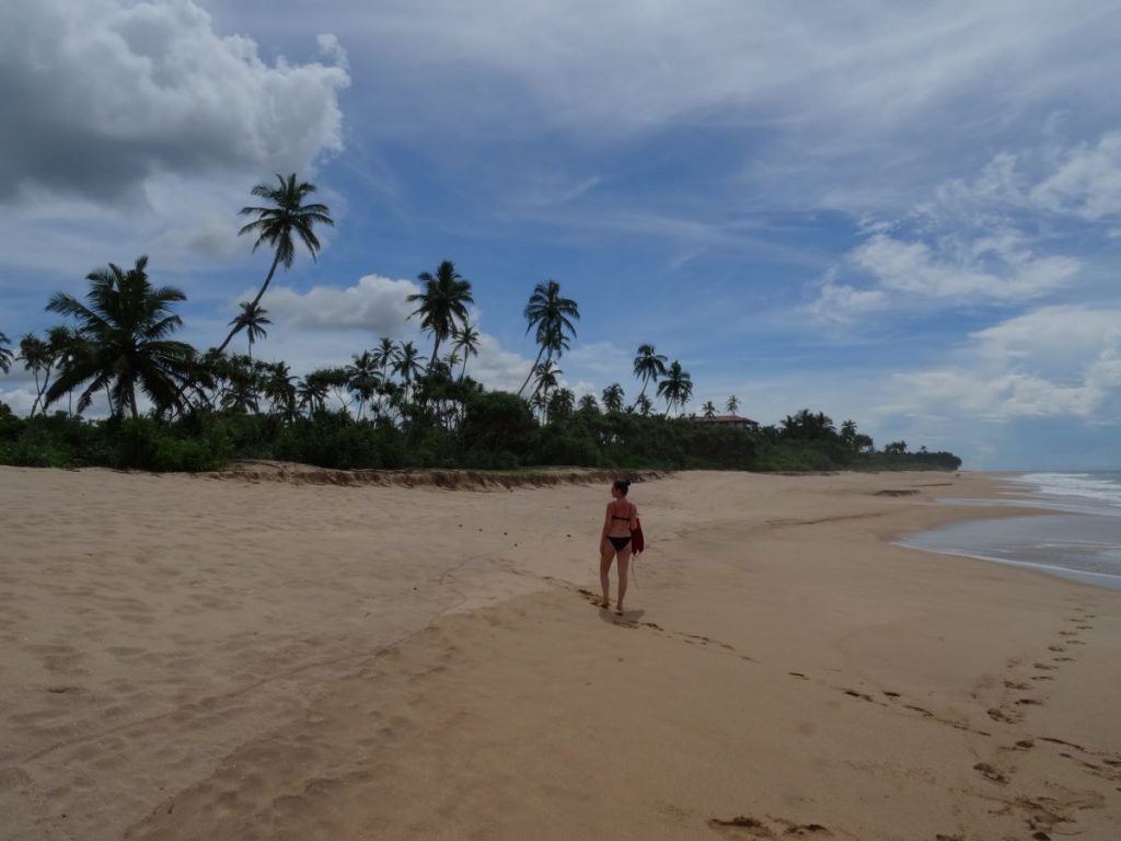 lady walking along rekawa beach sri lanka