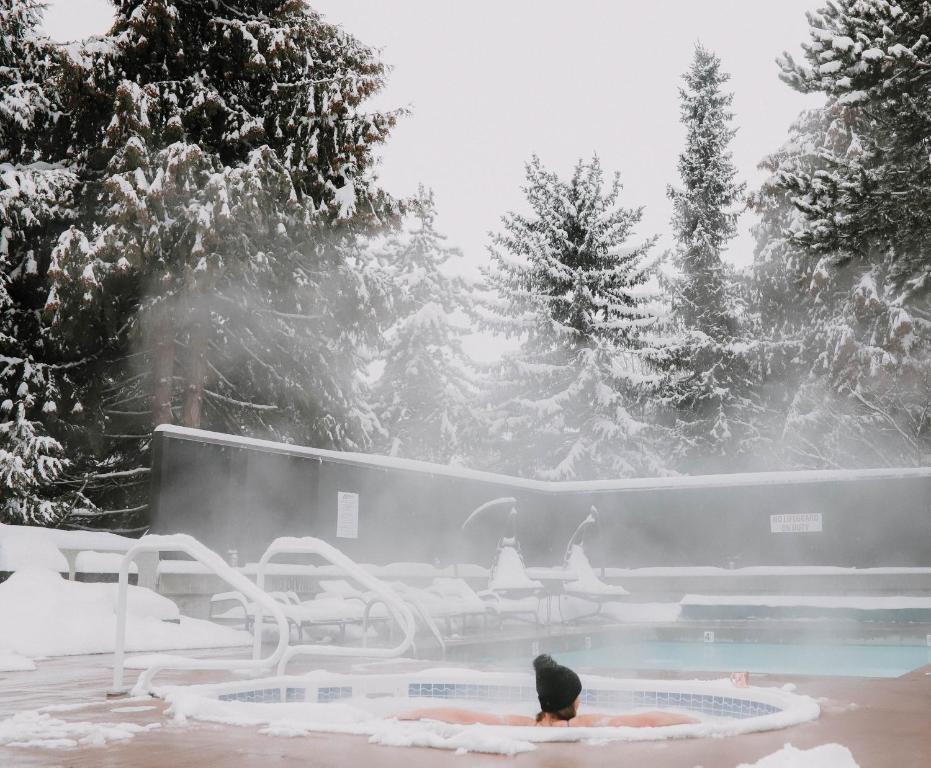 hot tub at adara hotel whistler in snow