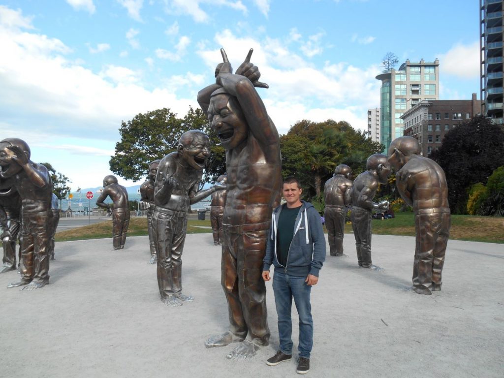 man at laughing statues english bay vancouver