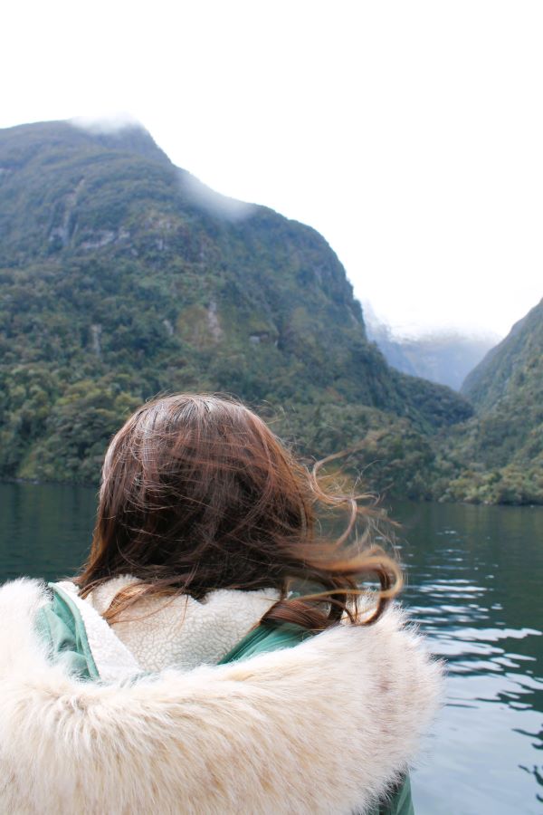 lady looking at waterfall doubtful sound