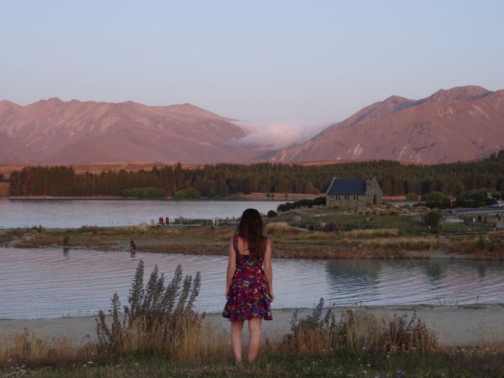 lady at lake tekapo at sunset