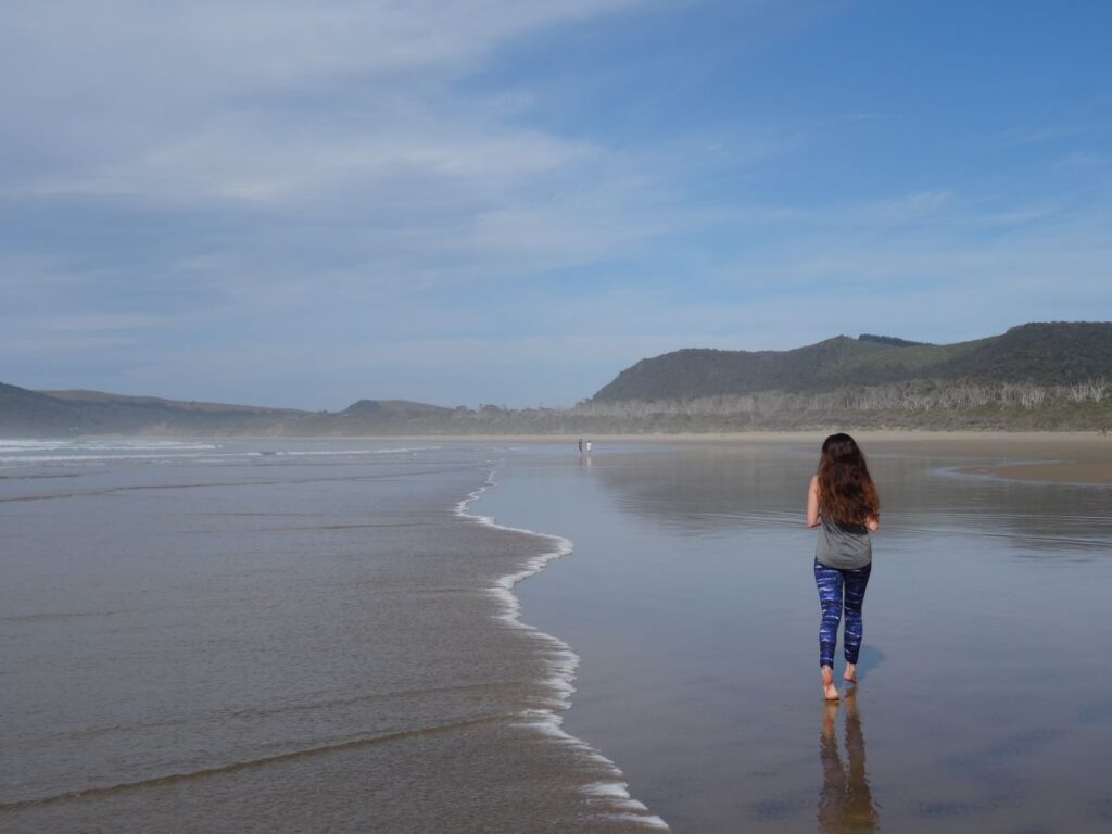 lady on cathedral bay beach