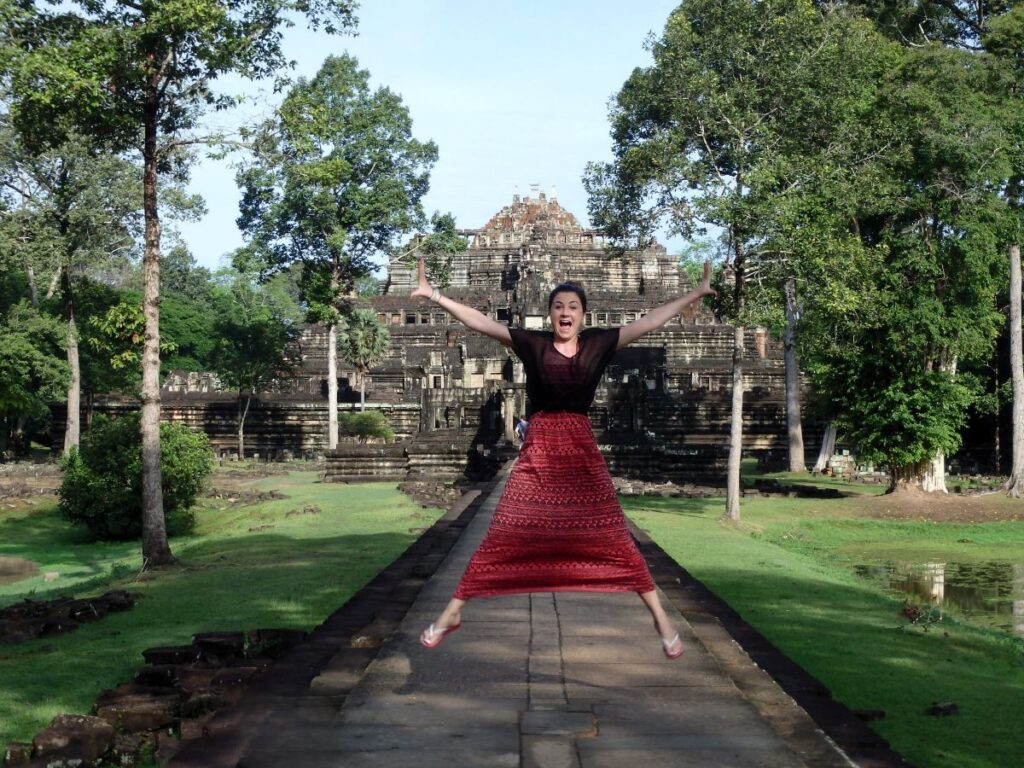 lady jumping at angkor wat temple