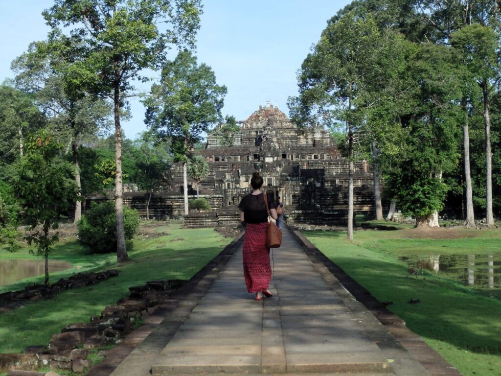lady walking to temple at angkor cambodia