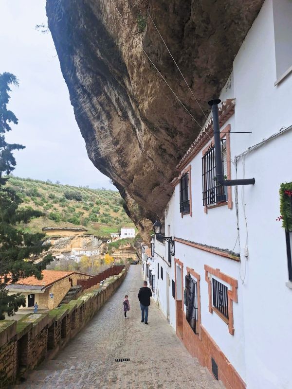 man and girl walk street setenil de las bodegas