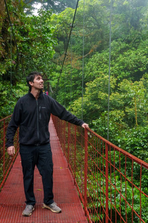 man hanging bridge monteverde