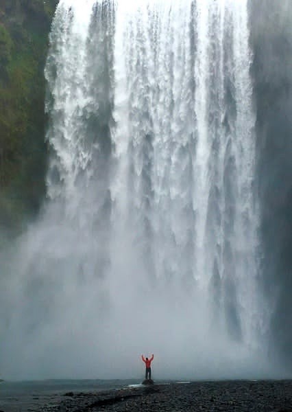 skogafoss waterfall person posing