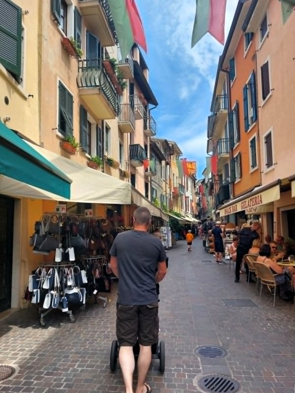 man walking bardolino street